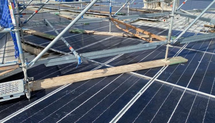 Scaffolding set up over solar panels