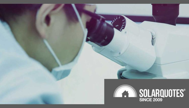 scientist looking into microscope