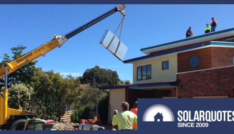 A crane hoists a solar thermal panel